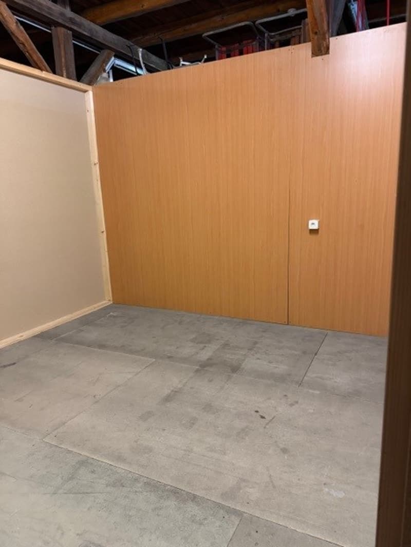 wooden wall, brown wooden door, cement floor