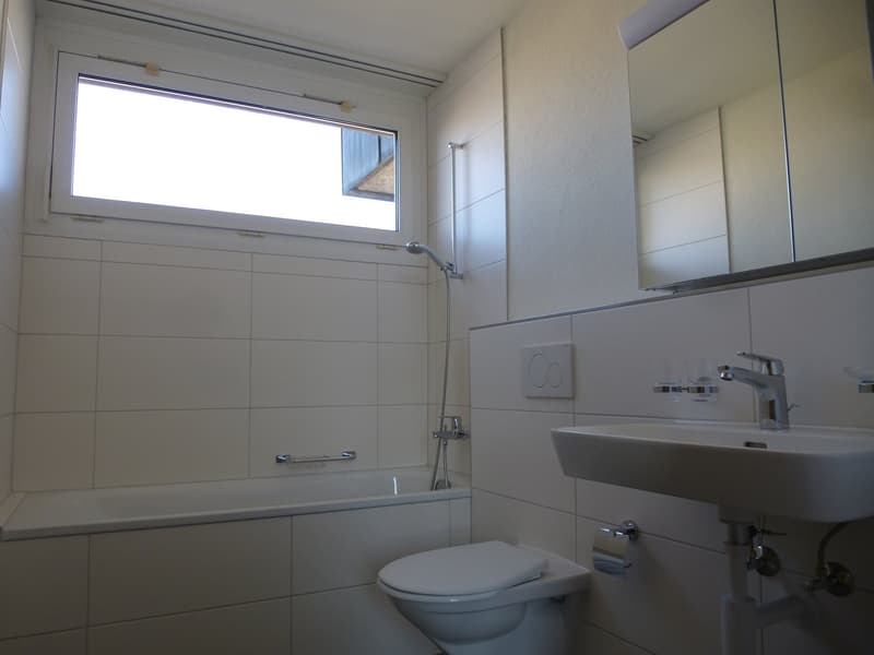 Bathroom: tiled floor, bathtub, shower, toilet, sink, window