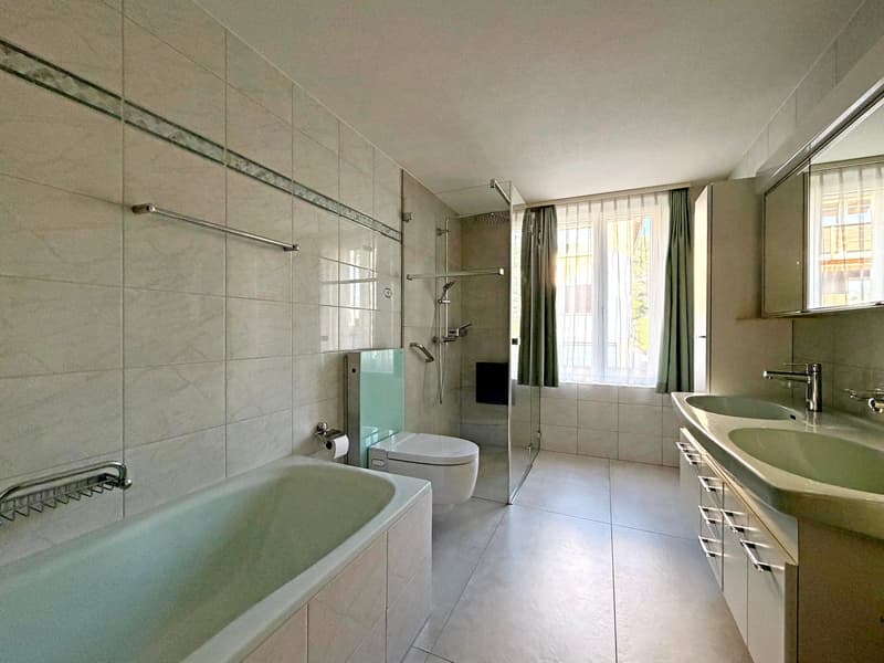tiled walls, double sink, bathtub, shower, toilet, mirror, towel rack, faucets