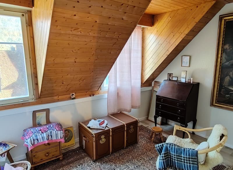 A wooden desk, chest, stool, chair, carpet, cabinet, window with curtain, frame, plug, picture.
