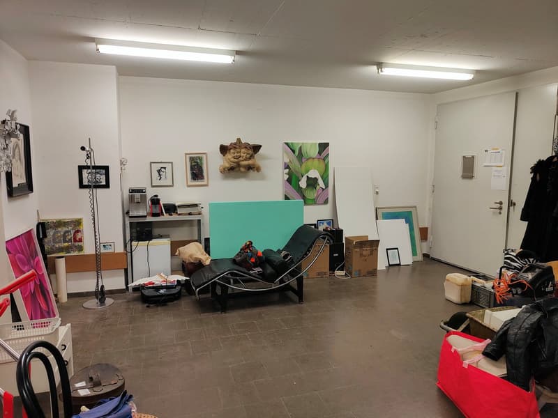 Chaise lounge, desk, storage boxes, artworks, radiator, floor lamp, shelves