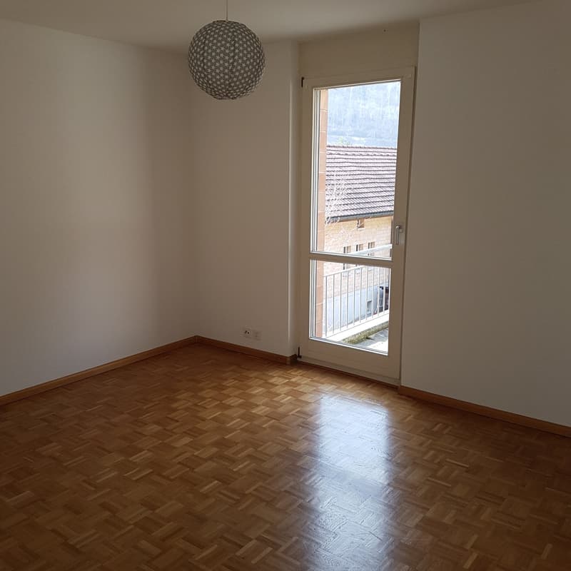 Empty room, white walls, wooden floor, glass door, balcony outside