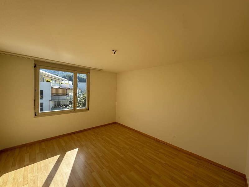 empty room, wooden floor, large window, view of buildings and trees