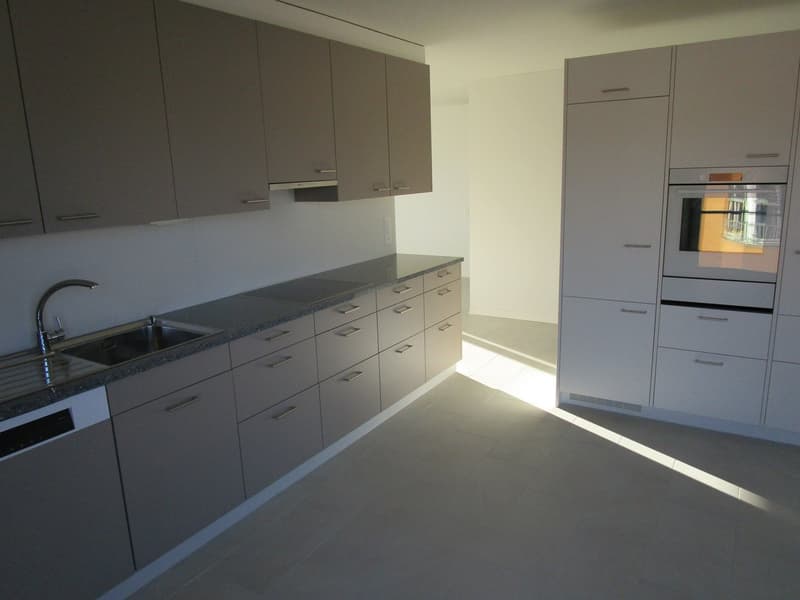 empty kitchen with tiled floor, oven, sink, dishwasher, many cabinets, no appliances
