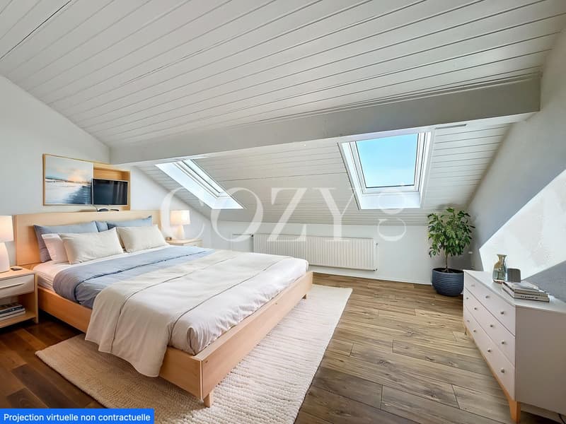 Spacious attic bedroom with slanted white ceiling, hardwood flooring, large windows and skylights, wooden bed frame, dresser, and potted plant