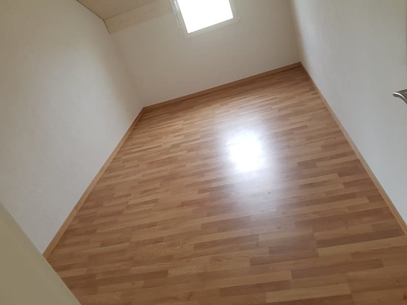Empty room with wooden floor and white walls
