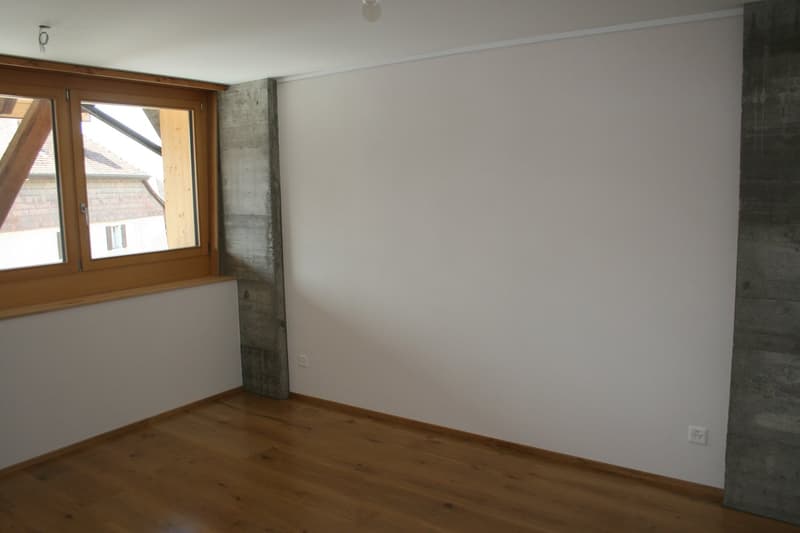 empty room, wooden floor, white walls, large window, concrete column