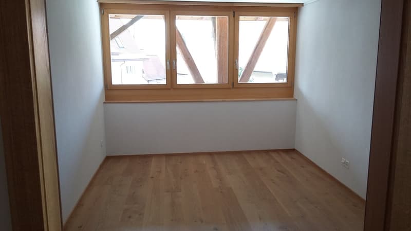 empty room, wooden floor, white walls, large window, power outlets