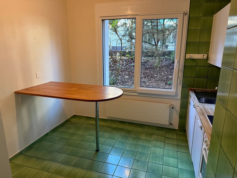 small kitchen, green tiles, foldable table, sink, electrical outlets, white appliances