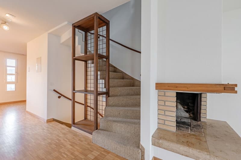wooden staircase, fireplace, white walls, wooden flooring