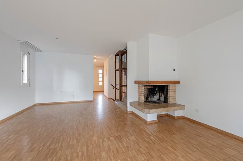 empty room, wooden floor, white walls, fireplace, open door, staircase
