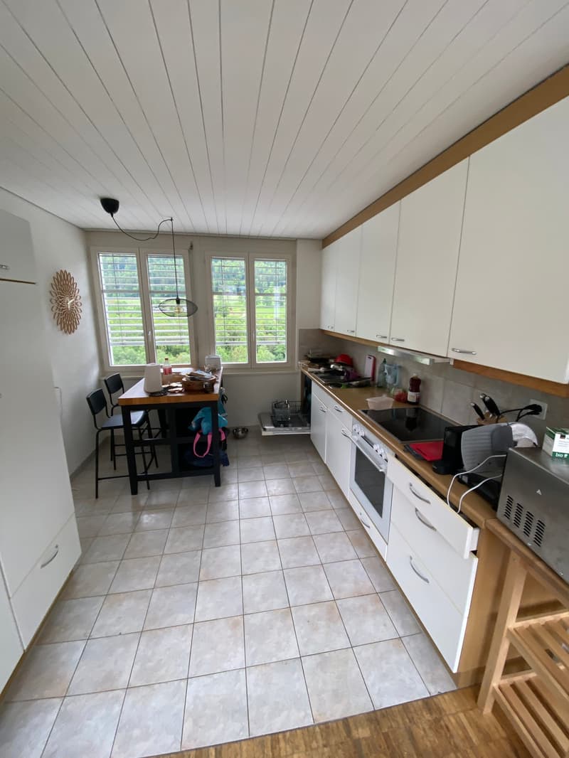 kitchen with dining area, white cabinets, tiled floor, large windows, table, chairs, kitchen appliances