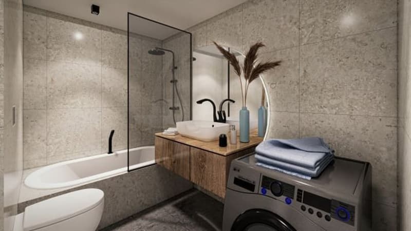 Modern bathroom with bathtub, shower, sink, grey tiled walls, grey tiled floor, wooden countertop, blue towels on the washing machine