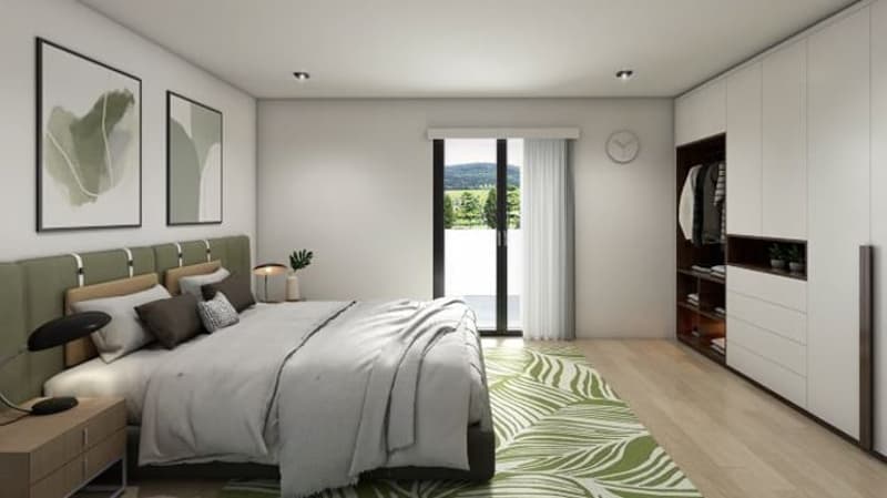 master bedroom with a bed, nightstands, a rug, a closet, and a sliding door leading to a balcony