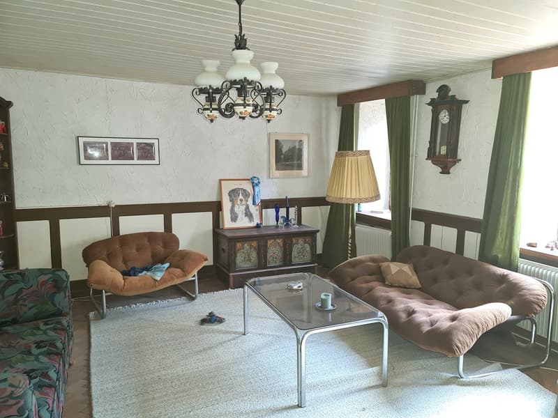 3 couches, wooden cabinet, lamp, chandelier, frame, carpet, coffee table