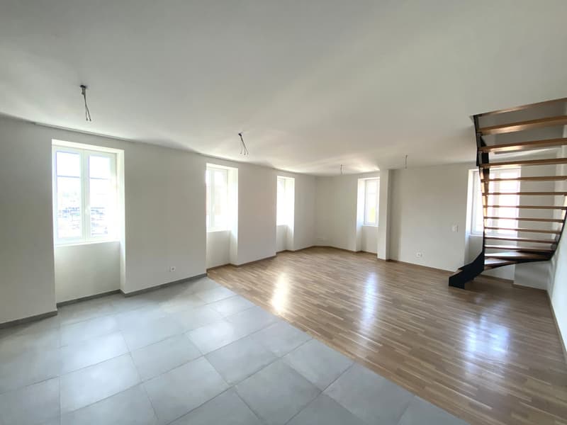 empty room with wooden and tile floors, 3 windows, a staircase