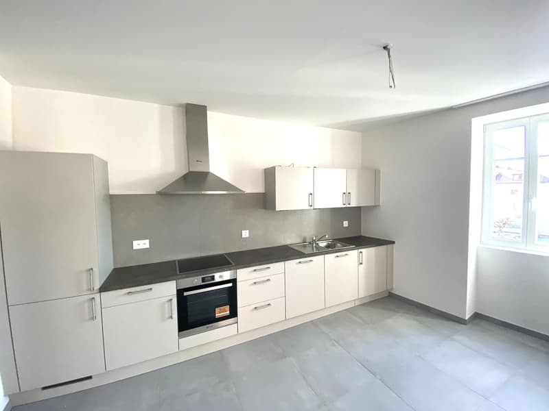 white cabinets, grey tiled floor, gas stove, built-in oven, stainless steel extractor, stainless steel sink, kitchen island