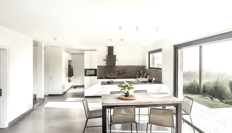 modern kitchen, dining area with a glass door leading to a terrace with garden view
