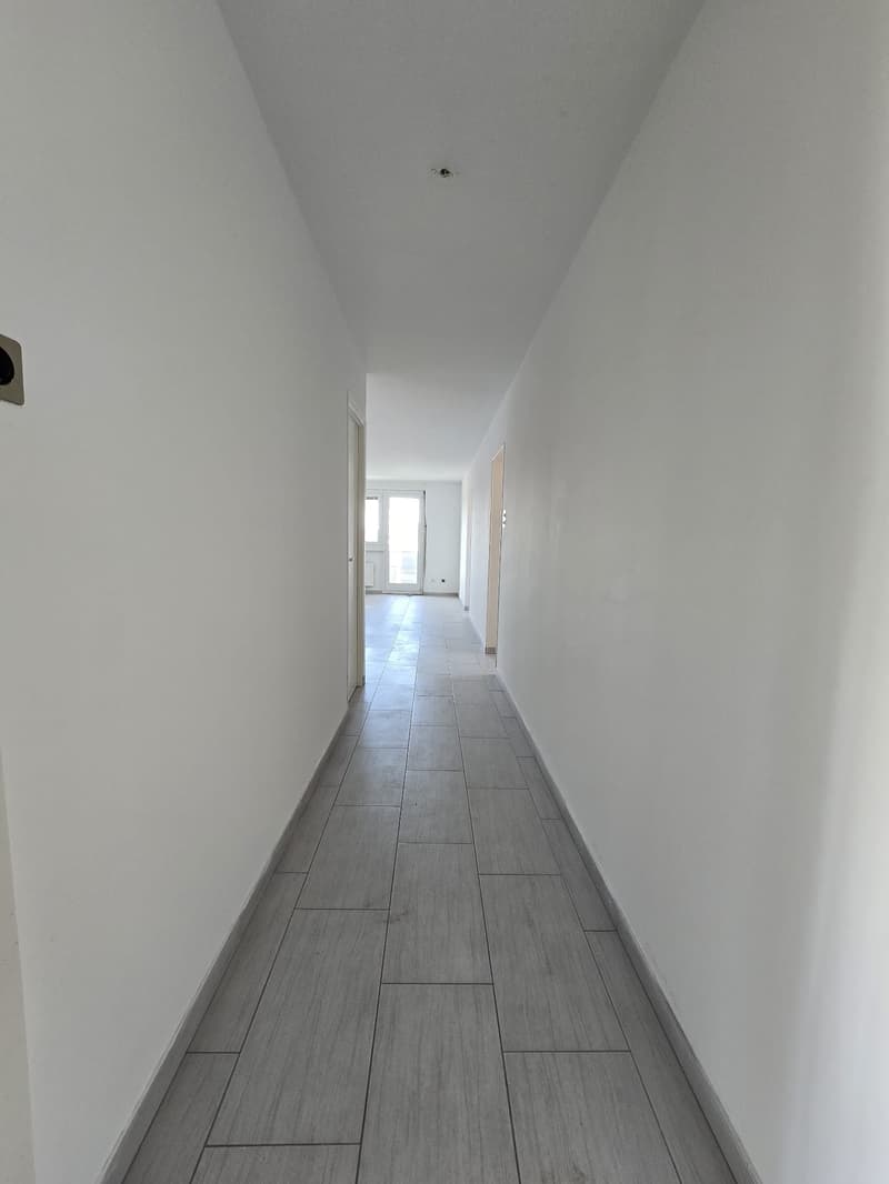 tiled floor, two doors on left and right sides, one is window