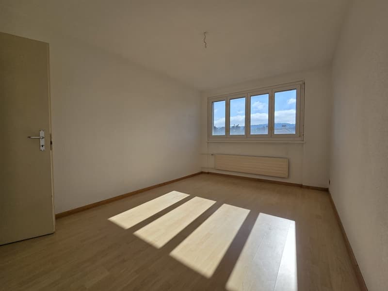 empty room, wooden floor, large window, white walls, open door, sunlight