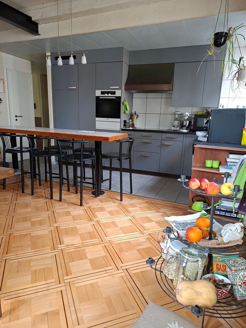 Contemporary kitchen with dining area, wooden floor, open kitchen layout, modern appliances