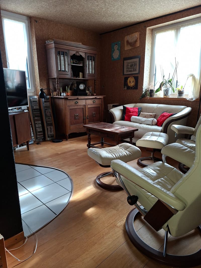 white couch with pillows, hardwood flooring, wooden coffee table, large windows