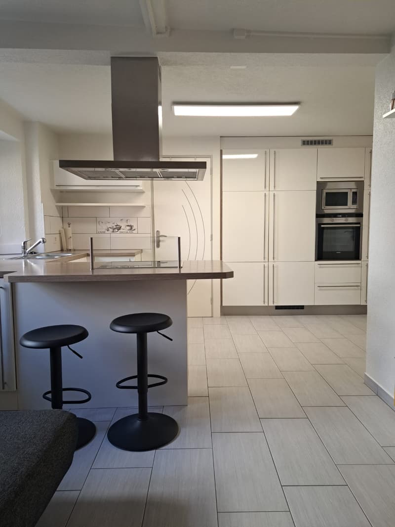 white cabinets, countertop, microwave, oven, sink, faucet, stools, flooring