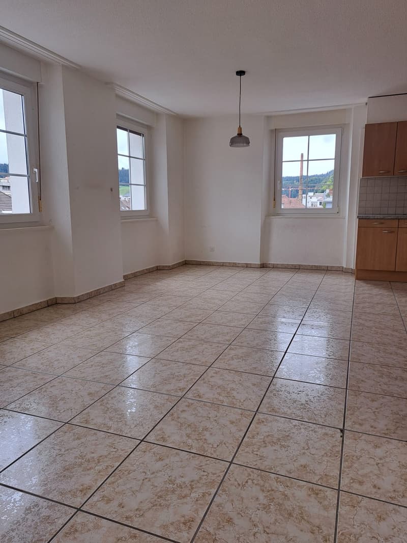 empty room, tiled floor, white walls, two windows, wooden cabinets, hanging lamp
