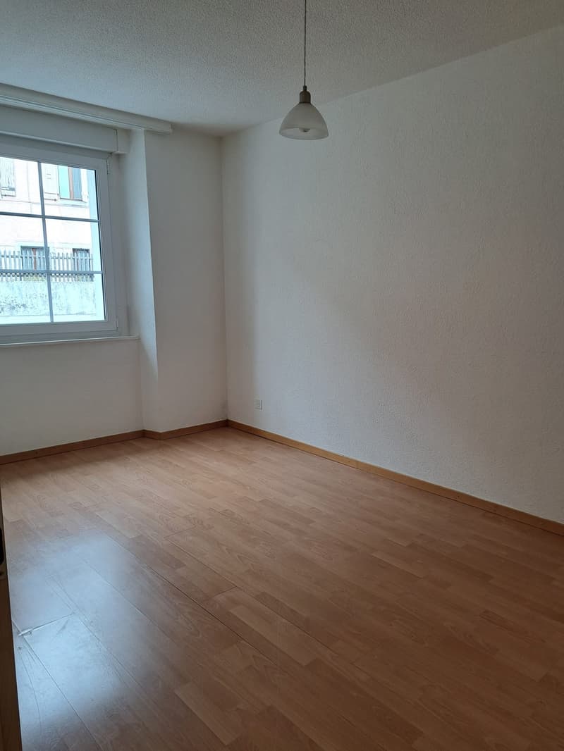 empty room, wooden floor, white walls, large window, power outlet