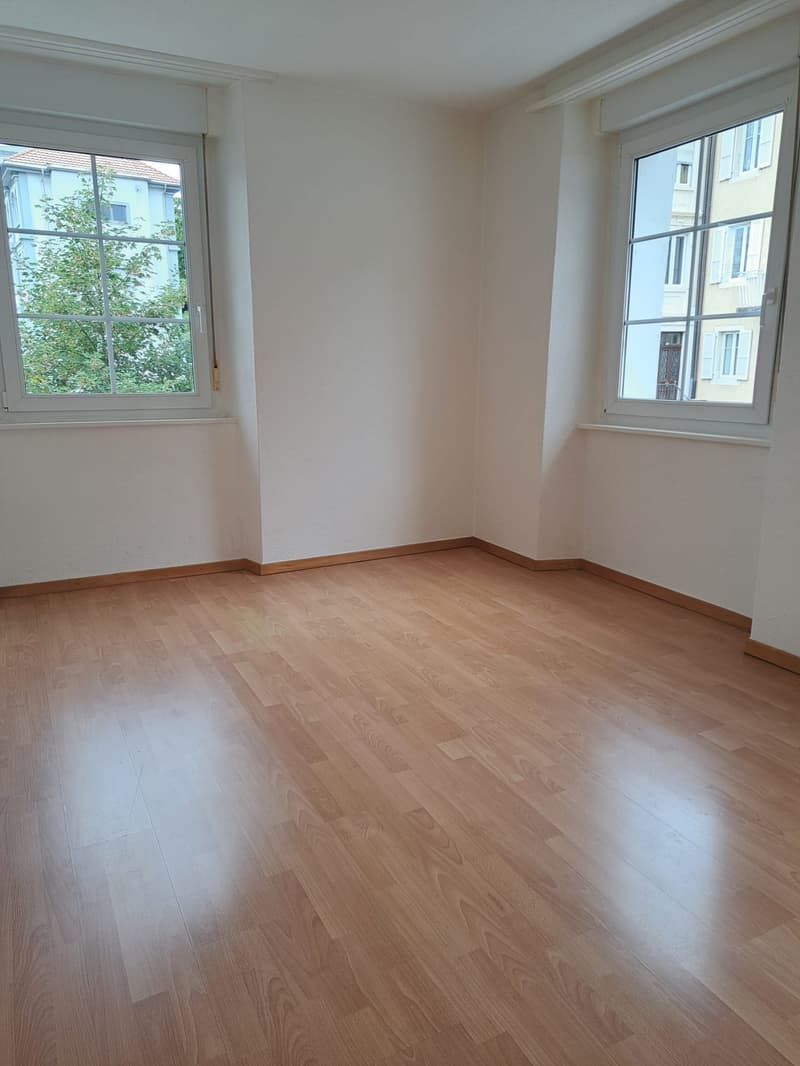 empty room, wooden floor, white walls, two windows, wooden window frames