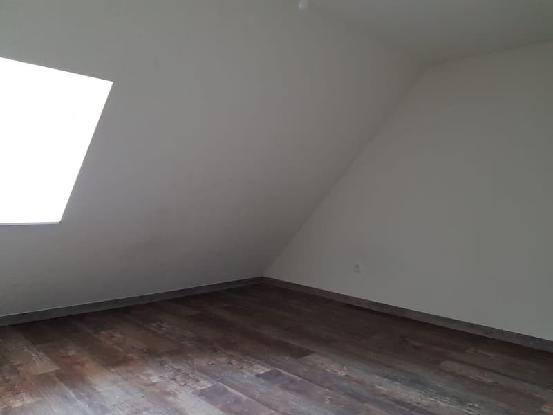 empty room, wooden floor, white walls, slanted ceiling, window