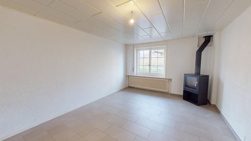 empty room with fireplace, windows, radiator, tile flooring