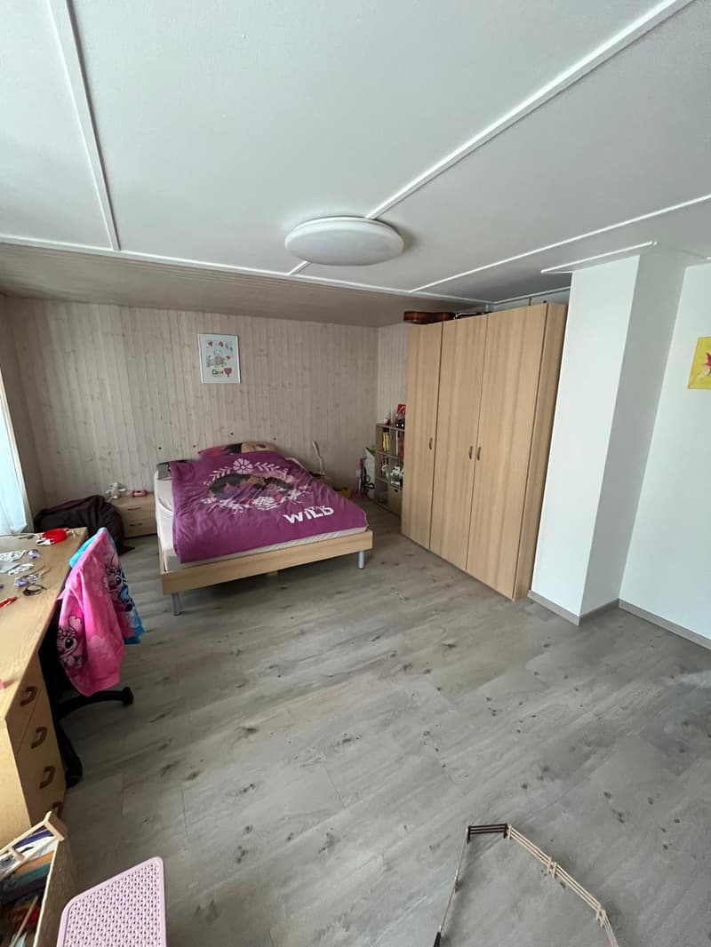 Bedroom with a bed, wardrobe, and desk