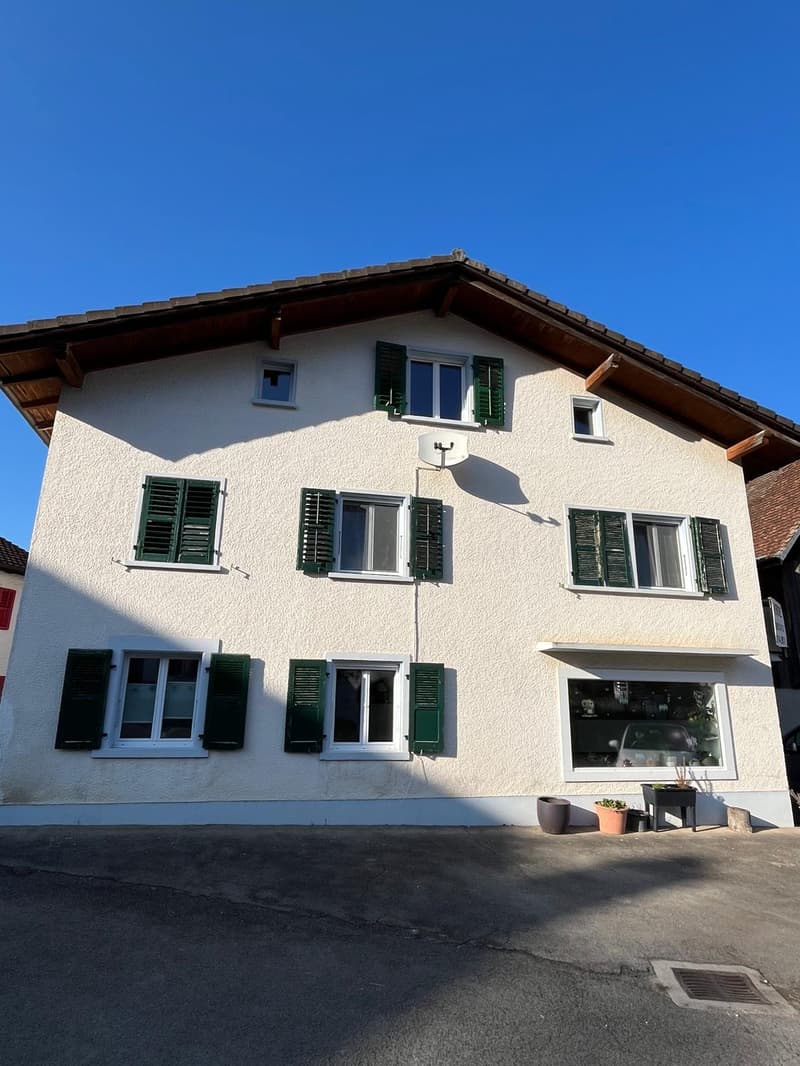 2 story house, white walls, green shutters, satellite dish, entrance with steps