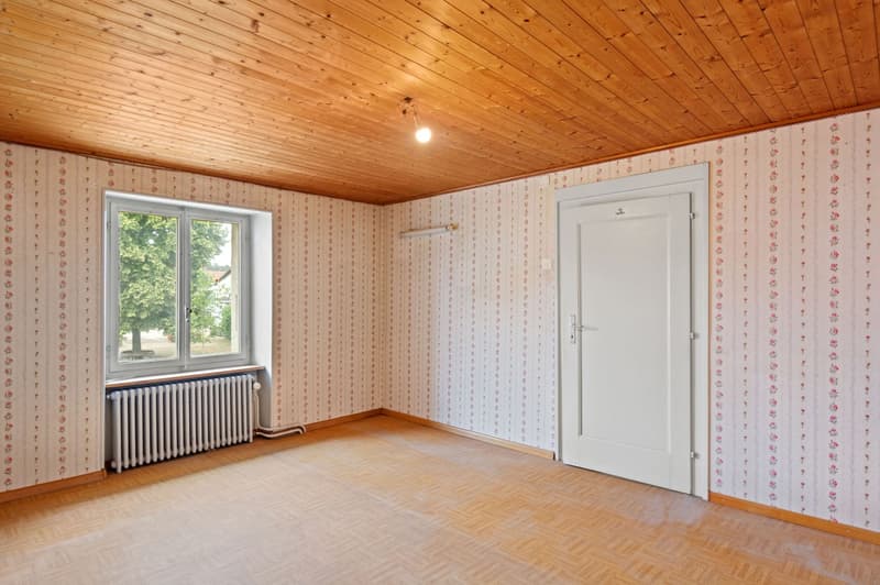 Wooden ceiling, white radiator, wooden floor, white walls, white door