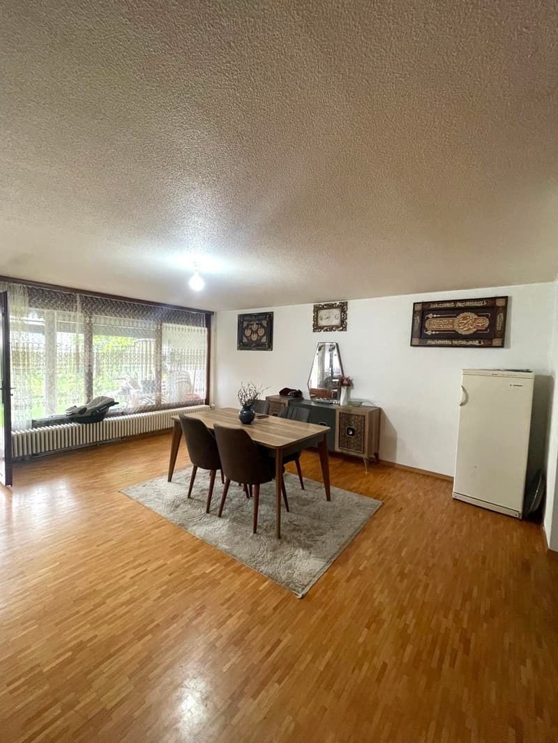 wooden floor, dining area with table and chairs, carpet, radiators, fridge, mirror, window, paintings