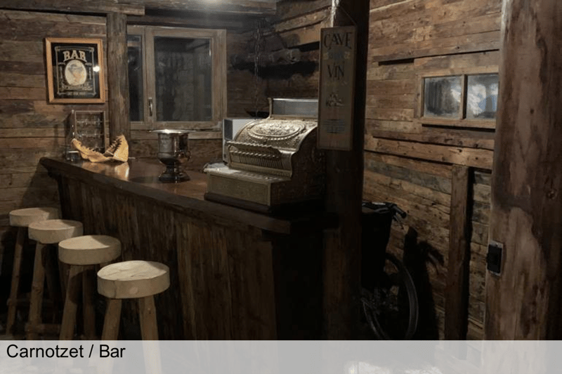 Bar counter, wooden walls, 4 stools, window, bicycle leaning on the wall