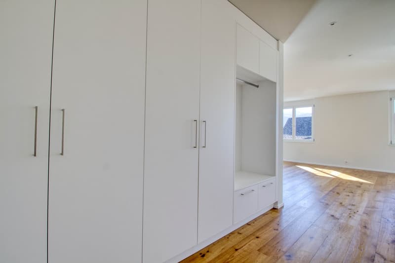 white cabinets, wooden floor, large windows