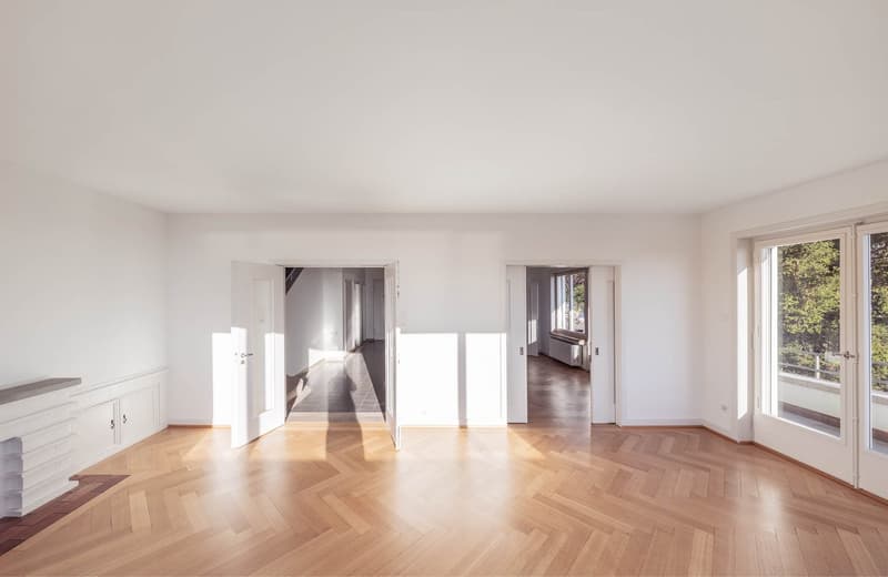 Empty room, large windows, sliding doors, wooden floors, open doorways, balcony