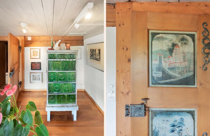 a hallway with wooden floor, a green cabinet, decorative pieces on top, a door with unique wooden panels, a light fixture