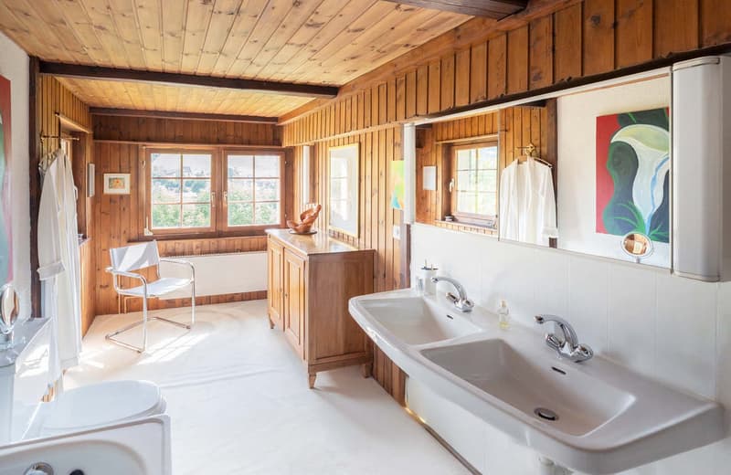 bathroom, double sink, toilet, wooden cabinet, mirror, wooden chair, towels, radiator