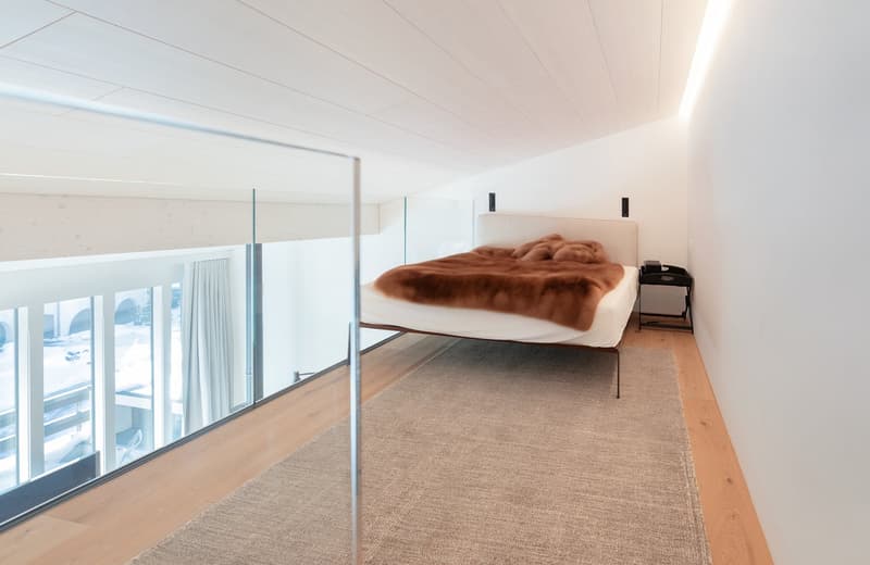 elevated bed, beige rug, glass wall, terrace, large window