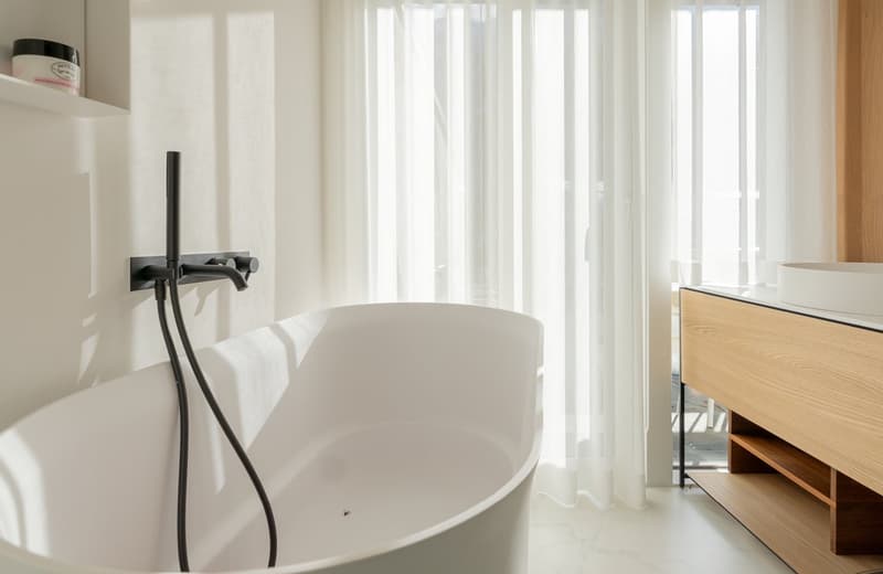white bathtub, modern bathroom design, white vanity, white sink, white curtain, white shelf