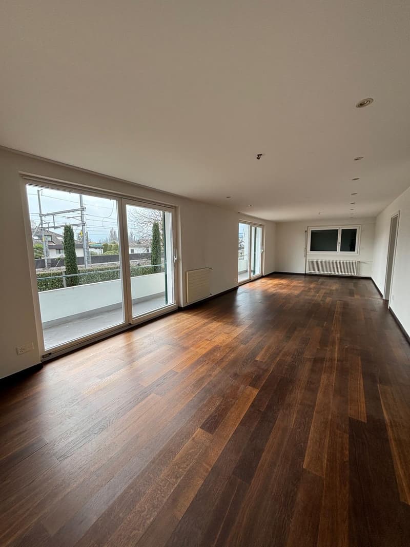 empty room, hardwood floors, sliding glass doors, balcony, white walls, white ceiling, radiators