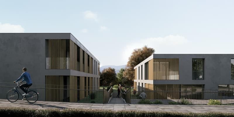 Contemporary apartment complex with grey facade, wooden balconies, glass doors and windows, pathway, metal fences, greenery.