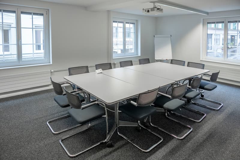 Large table, chairs, whiteboard, large windows, projector