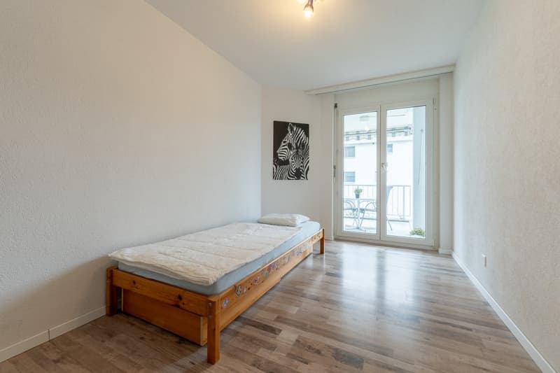 single bed, wooden, balcony through sliding doors, minimalist