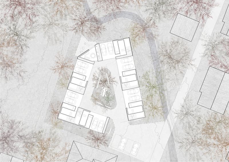 Aerial view of a parking lot with multiple parking spaces and a central green area.