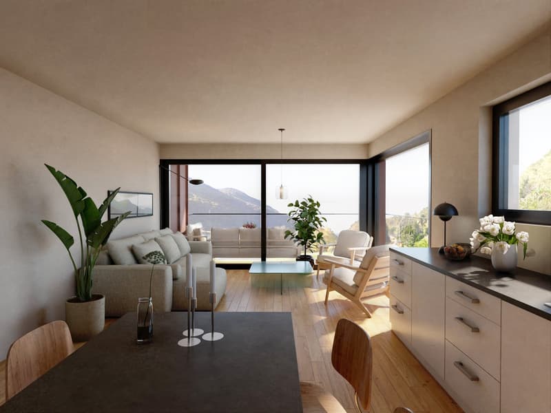 Spacious living room with large windows offering a scenic view of the mountains and lake. The room features a comfortable sofa, armchair, and a wooden dining table. There are also various decorative elements such as plants, vases, and a TV mounted on the