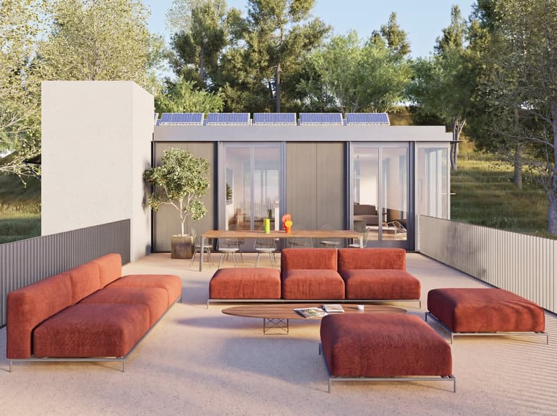 Modern outdoor living space with a terrace, solar panels on the roof, large windows, and a view of the surrounding landscape.